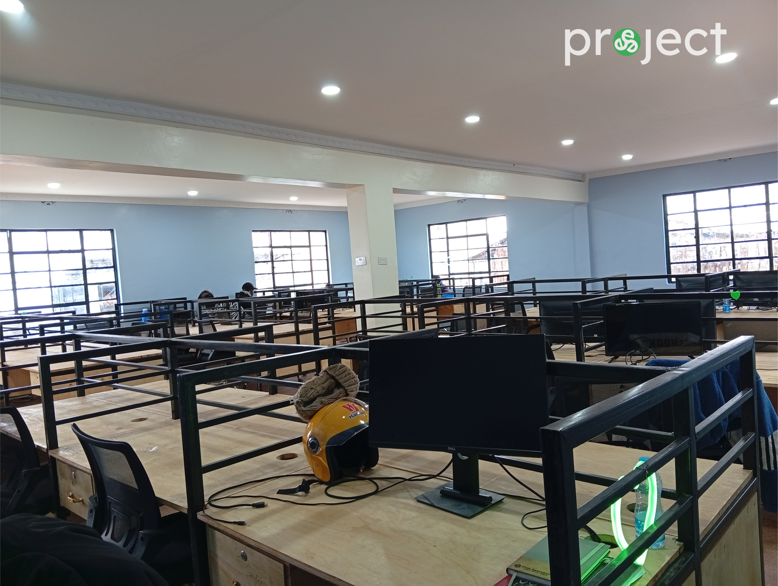 Large open tech floor at the David Connor Trinitech Center featuring rows of desks, computers, and seating for remote work and digital service delivery.